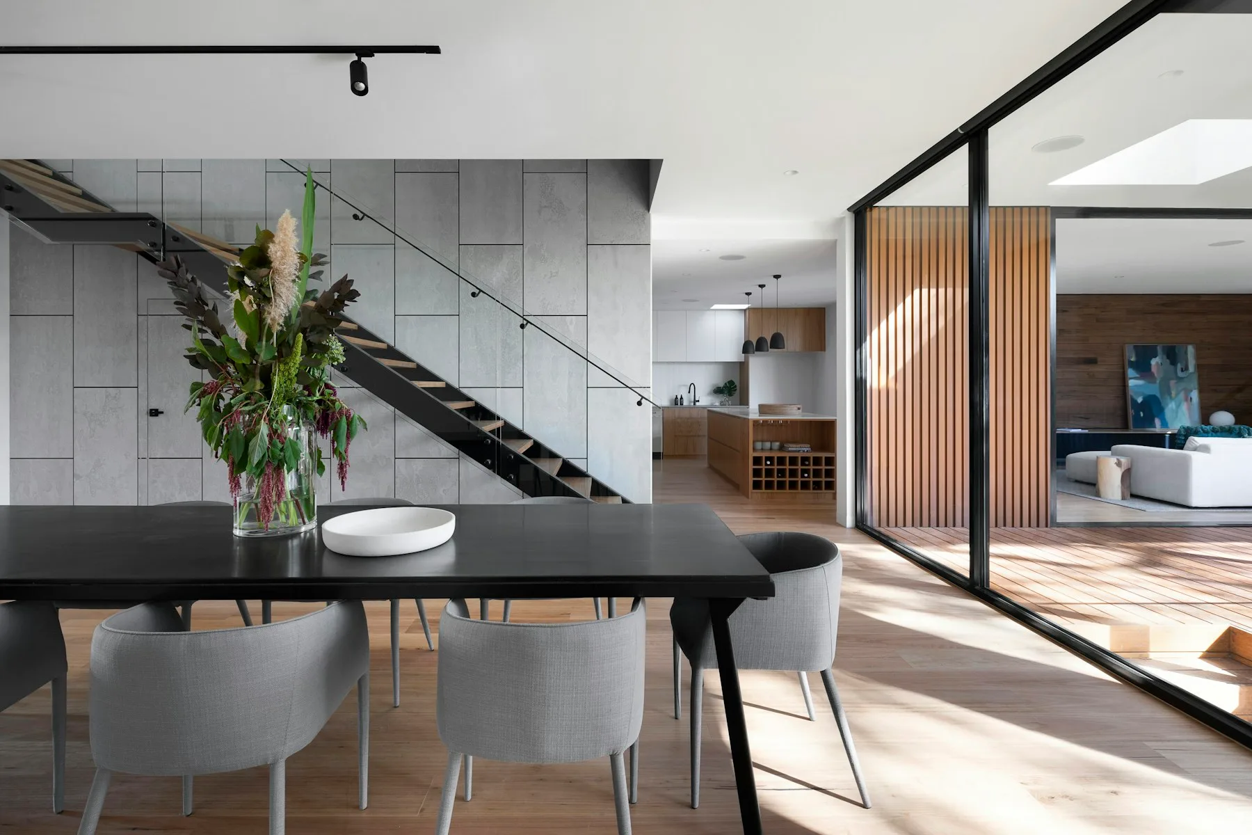 Quiet interior with natural textures and a view into a planted courtyard